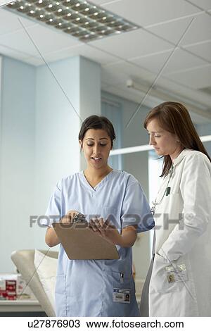 Nurse and doctor in discussion View Large Photo Image Stock Image - Nurse and doctor in discussion. Fotosearch
