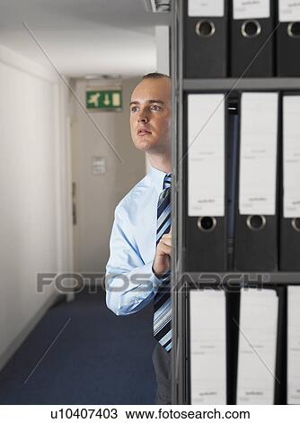 Office worker hiding behind files View Large Photo Image Stock Image - Office worker hiding behind files. Fotosearch