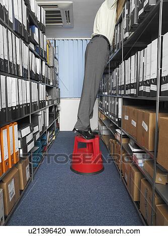 Office worker looking amongst files View Large Photo Image Stock Image - Office worker looking amongst files. Fotosearch