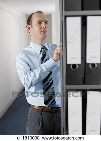 Office worker looking at files View Large Photo Image Stock Photo - Office worker looking at files. Fotosearch