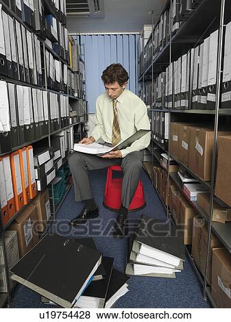 Office worker surrounded by files View Large Photo Image Stock Photo - Office worker surrounded by files. Fotosearch