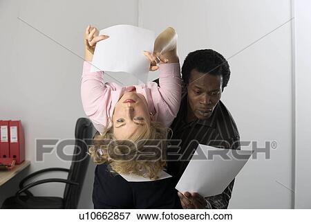 Stock Photo - office workers reading papers. Fotosearch