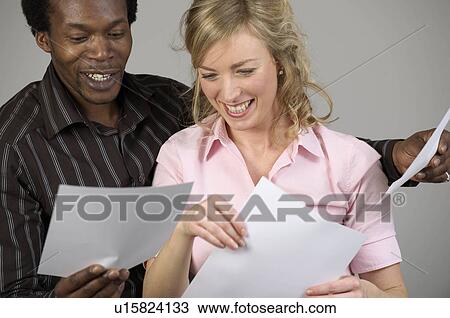 office workers reading sheets of paper View Large Photo Image Stock Image - office workers reading sheets of paper. Fotosearch