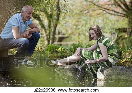 old man and young girl at pond View Large Photo Image Stock Photo - old man and young girl at pond. Fotosearch