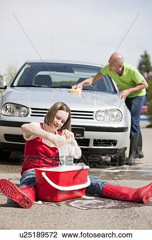 Stock Image - old man and young girl washing car. Fotosearch