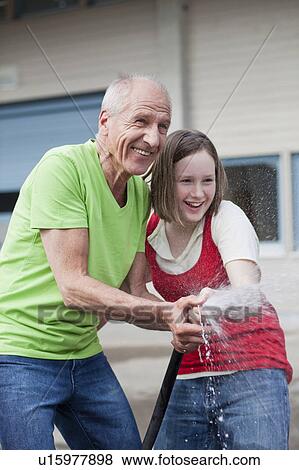 old man and young girl washing car View Large Photo Image Stock Photo - old man and young girl washing car. Fotosearch