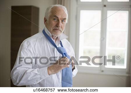 old man putting on tie View Large Photo Image Stock Photo - old man putting on tie. Fotosearch