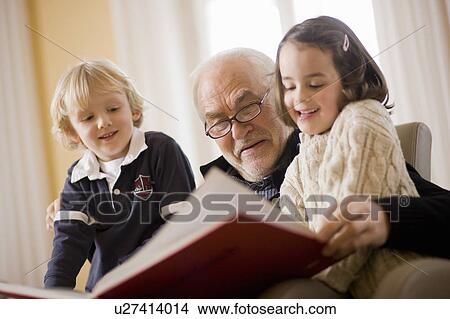 old man reading book to children View Large Photo Image Picture - old man reading book to children. Fotosearch