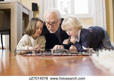 old man reading book to children View Large Photo Image Stock Photo - old man reading book to children. Fotosearch