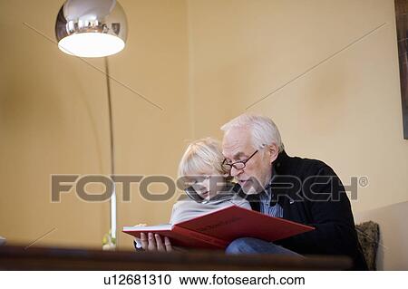 old man reading book to young boy View Large Photo Image Stock Image - old man reading book to young boy. Fotosearch