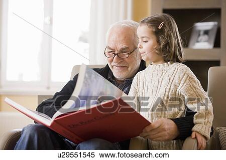 old man reading book to young girl View Large Photo Image Stock Photography - old man reading book to young girl. Fotosearch
