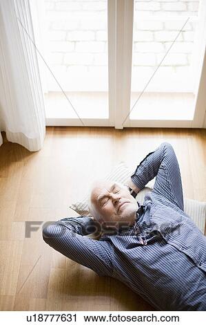old man relaxing on floor View Large Photo Image Stock Image - old man relaxing on floor. Fotosearch