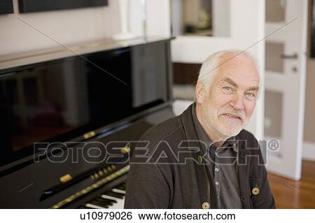 Stock Photograph - old man sitting at piano. Fotosearch