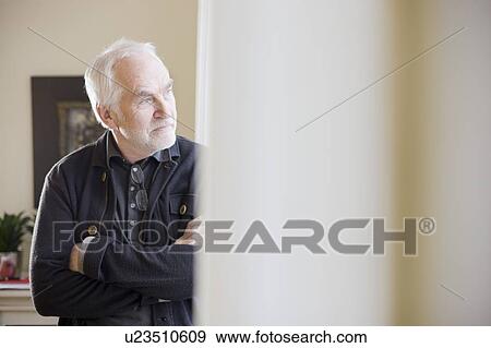 Stock Photo - old man standing in a room. Fotosearch