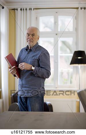 old man with book looking at viewer View Large Photo Image Stock Photography - old man with book looking at viewer. Fotosearch
