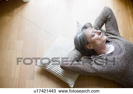 old woman relaxing on floor View Large Photo Image Stock Image - old woman relaxing on floor. Fotosearch