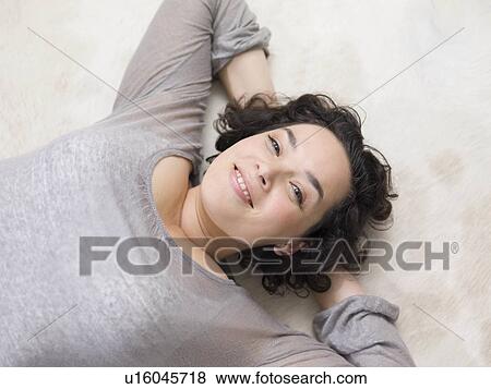 One woman relaxing on the floor. View Large Photo Image Stock Photo - One woman relaxing on the floor.. Fotosearch
