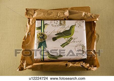 Picture - Parcel with gift being unwrapped. Fotosearch