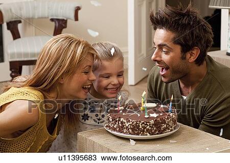 parents and child blowing out candles View Large Photo Image Stock Image - parents and child blowing out candles. Fotosearch