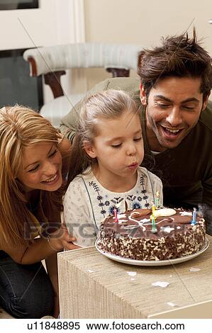 parents and child blowing out candles View Large Photo Image Stock Photography - parents and child blowing out candles. Fotosearch
