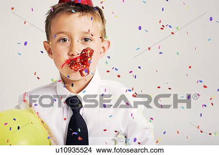 party boy blowing party blower View Large Photo Image Picture - party boy blowing party blower. Fotosearch