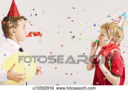 party boys blowing party blowers View Large Photo Image Stock Photo - party boys blowing party blowers. Fotosearch