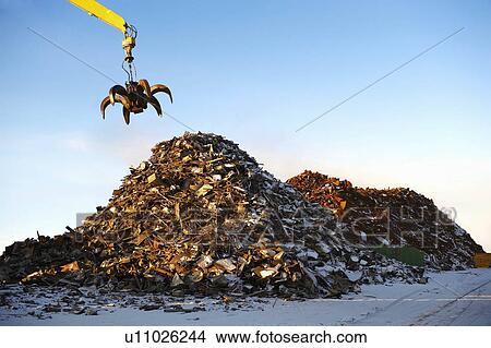 Picture - Pile of scrap metal with crane. Fotosearch