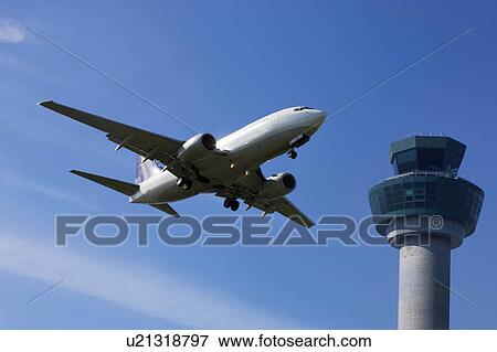Plane flying past control tower View Large Photo Image Stock Photo - Plane flying past control tower. Fotosearch
