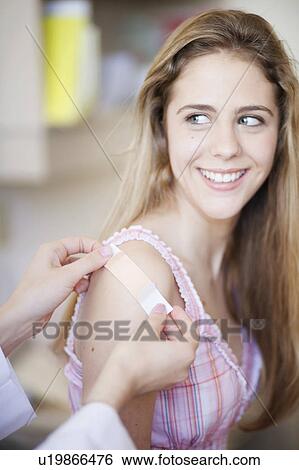 Stock Photograph - Plaster/bandage put on smiling girl. Fotosearch