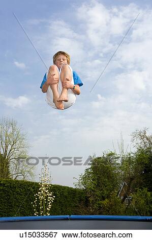 Playing on trampoline View Large Photo Image Stock Photo - Playing on trampoline. Fotosearch