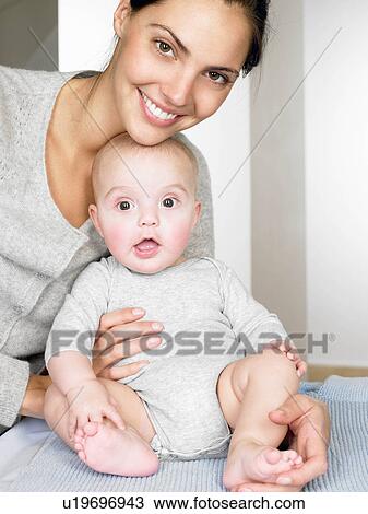 Stock Image - Portrait of a mother with her baby. Fotosearch