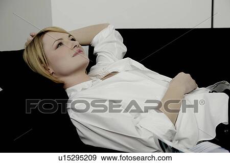 Portrait of a woman, laying on sofa. View Large Photo Image Stock Photo - Portrait of a woman, laying on sofa.. Fotosearch