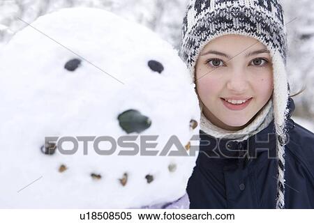 Portrait of teenage girl next to snowman View Large Photo Image Stock Photography - Portrait of teenage girl next to snowman. Fotosearch