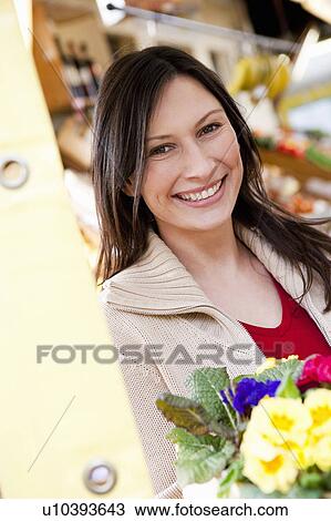 Stock Image - portrait of woman at marketplace. Fotosearch