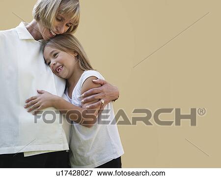 Pregnant mother hugging daughter View Large Photo Image Stock Photo - Pregnant mother hugging daughter. Fotosearch