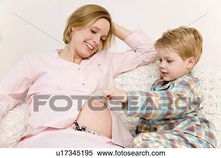 Stock Photography - pregnant woman and boy laughing. Fotosearch