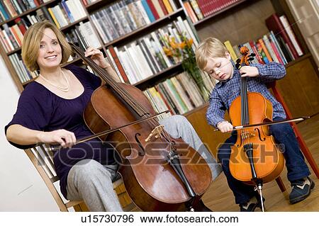 Stock Photograph - pregnant woman and boy playing Cello. Fotosearch