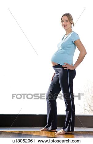 Stock Image - pregnant woman doing exercises. Fotosearch