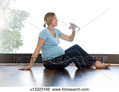 Stock Photograph - pregnant woman drinking water. Fotosearch