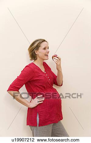 pregnant woman eating apple View Large Photo Image Stock Image - pregnant woman eating apple. Fotosearch