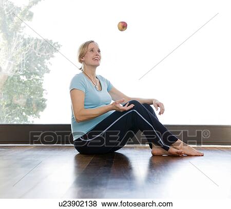 Stock Photo - pregnant woman juggling apple. Fotosearch