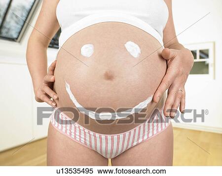 Pregnant woman with smiley on her belly View Large Photo Image Stock Photography - Pregnant woman with smiley on her belly. Fotosearch