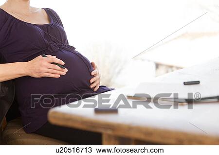 pregnant woman working in home office View Large Photo Image Stock Image - pregnant woman working in home office. Fotosearch