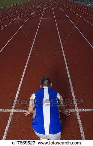 Stock Photo - rear view of athlete at start. Fotosearch