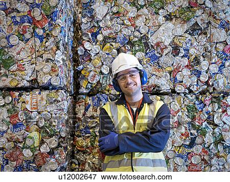 Recycle Worker With Bales Of Tin Cans View Large Photo Image Stock Photo - Recycle Worker With Bales Of Tin Cans. Fotosearch