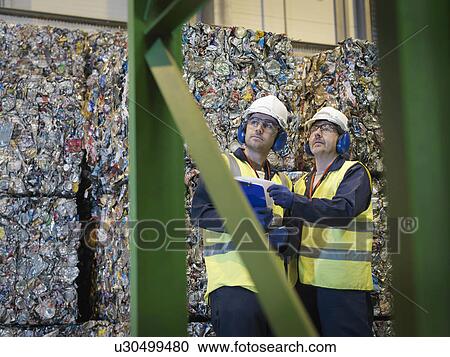 Stock Image - Recycle Workers With Bales Of Tin Cans. Fotosearch