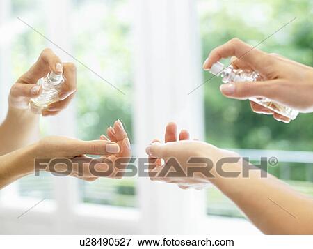 Reflection of hands spraying perfume View Large Photo Image Stock Photo - Reflection of hands spraying perfume. Fotosearch