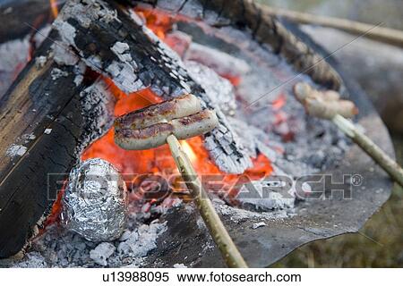 sausages roasting over barbecue fire View Large Photo Image Stock Photography - sausages roasting over barbecue fire. Fotosearch