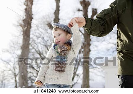 Scandinavian boy guided by fathers hand View Large Photo Image Stock Photo - Scandinavian boy guided by fathers hand. Fotosearch