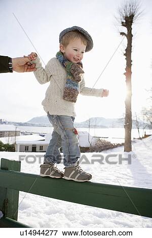 Scandinavian boy guided by fathers hand View Large Photo Image Stock Photo - Scandinavian boy guided by fathers hand. Fotosearch